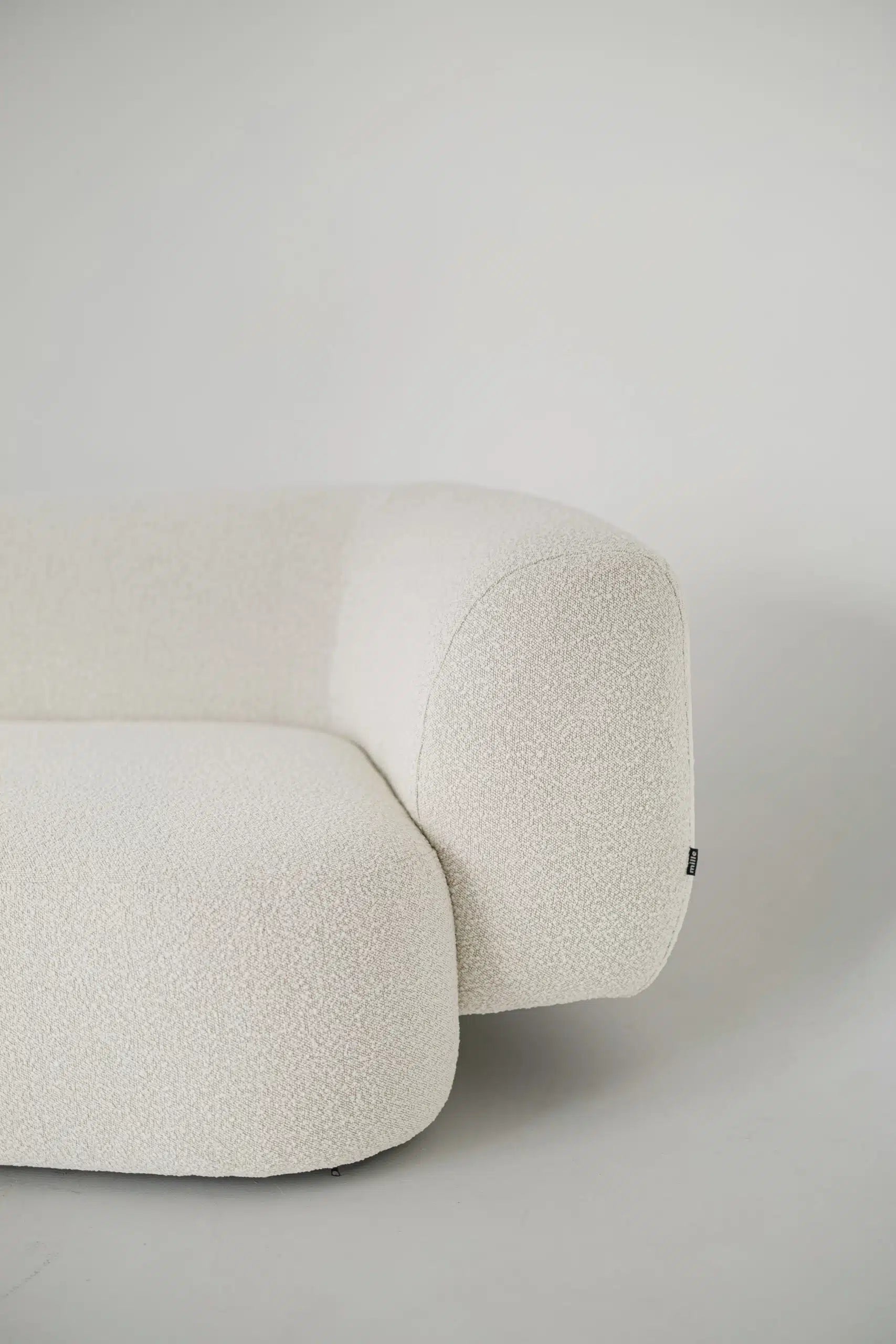 White textured boucle sofa on a plain background