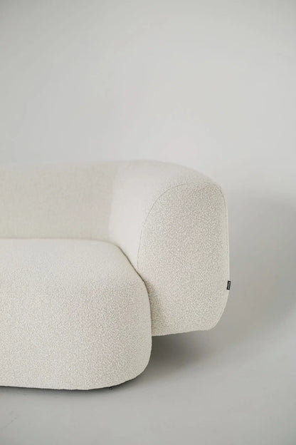 White textured boucle sofa on a plain background