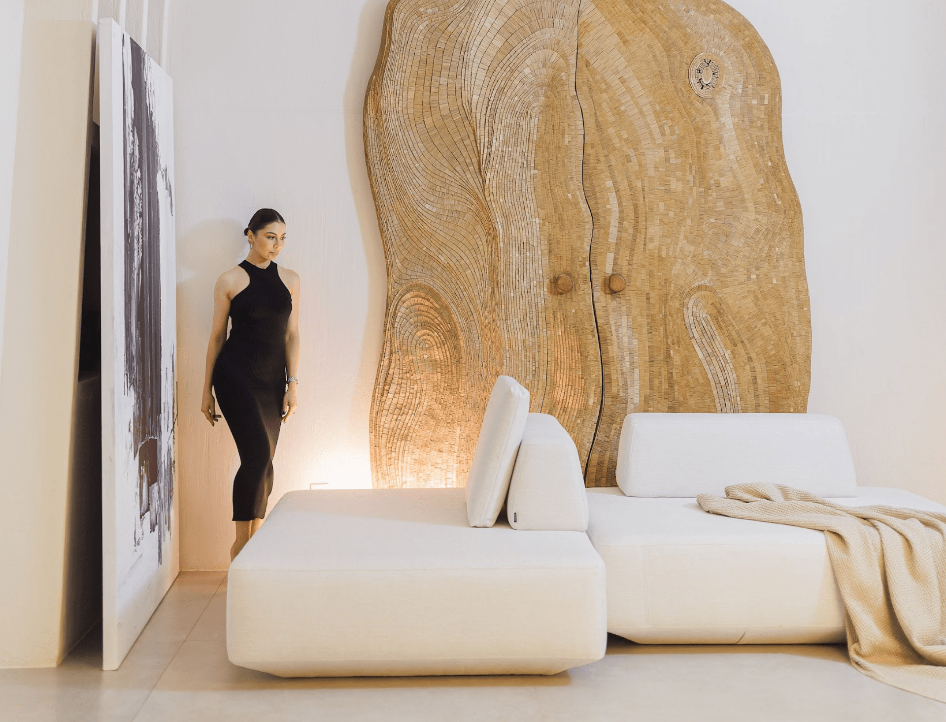 Modern living room with a large wooden door and white minimal sofa.