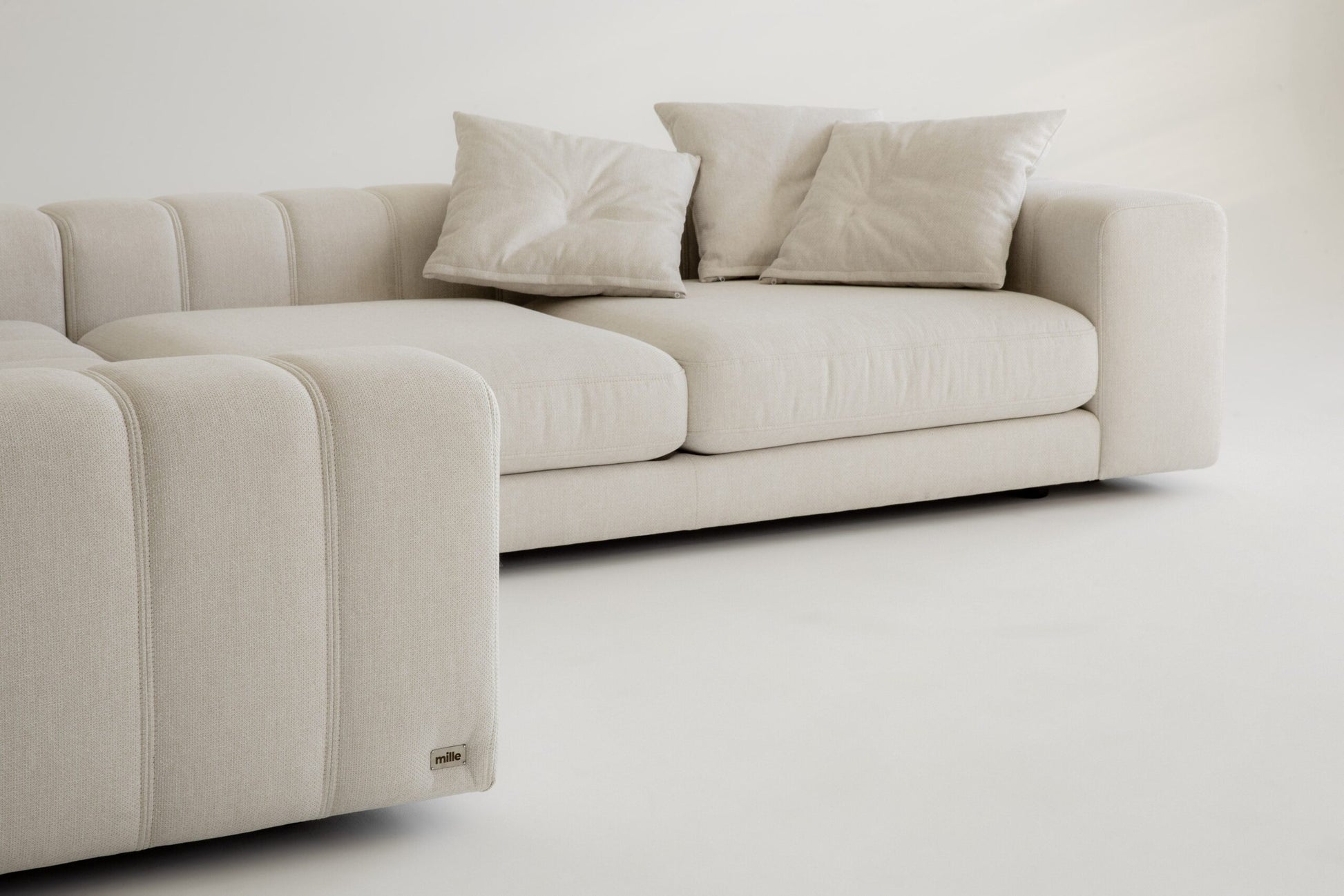 Luxury beige sofa with cushions on a white background