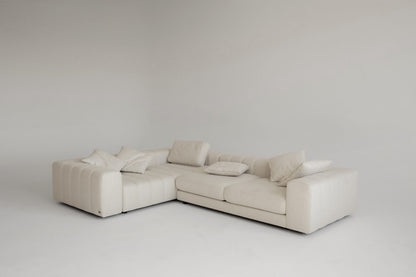 Luxury beige sectional sofa on a plain background