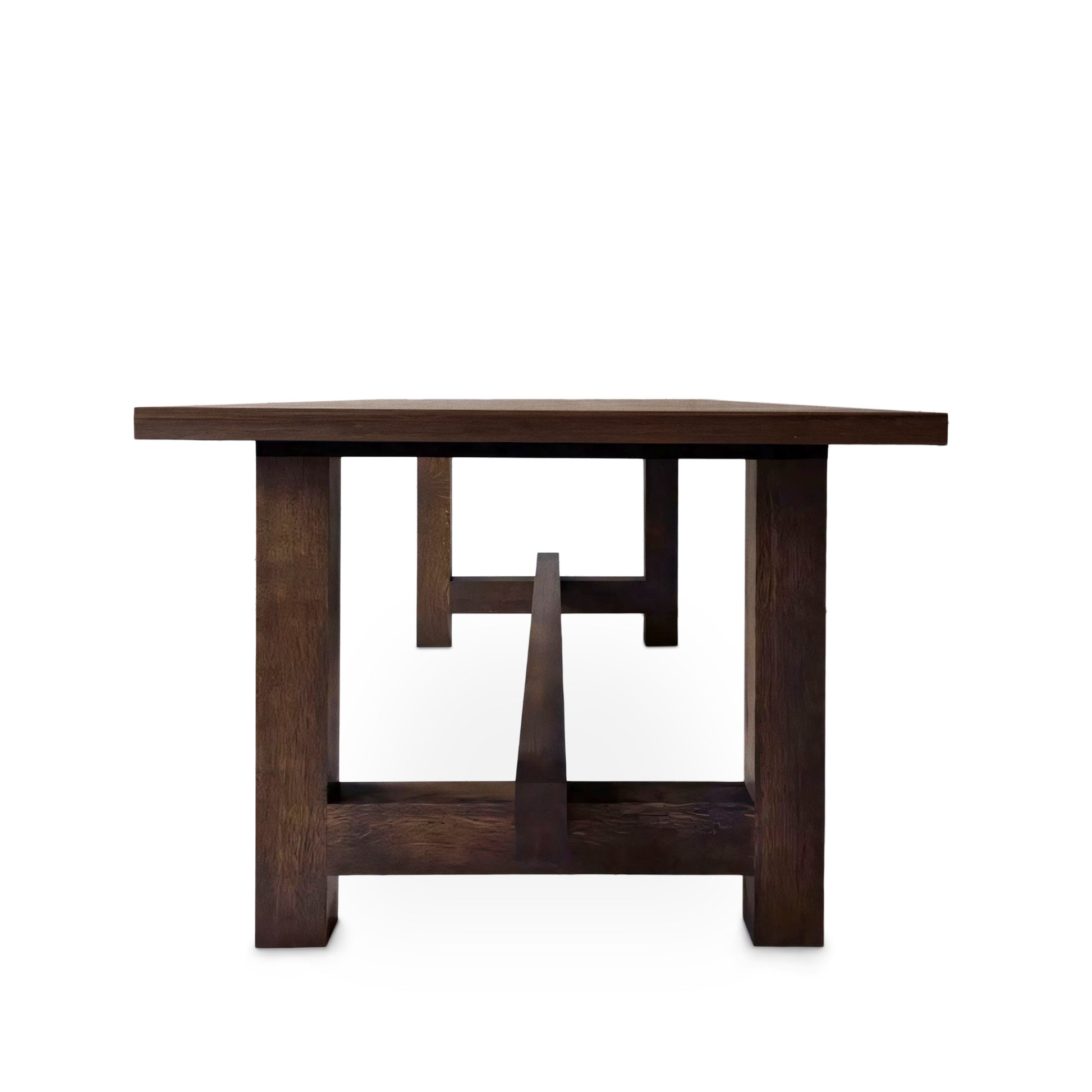 Detailed view of the Elsa rustic farmer-style dining table in rich chocolate oak, showcasing bespoke craftsmanship and FSC certified solid wood planks. This rectangular, extendable table by Talia Haus is a luxurious and sustainable piece, available in custom sizes and finishes including oak and walnut. A premium, handcrafted design perfect for elegant and timeless interiors.