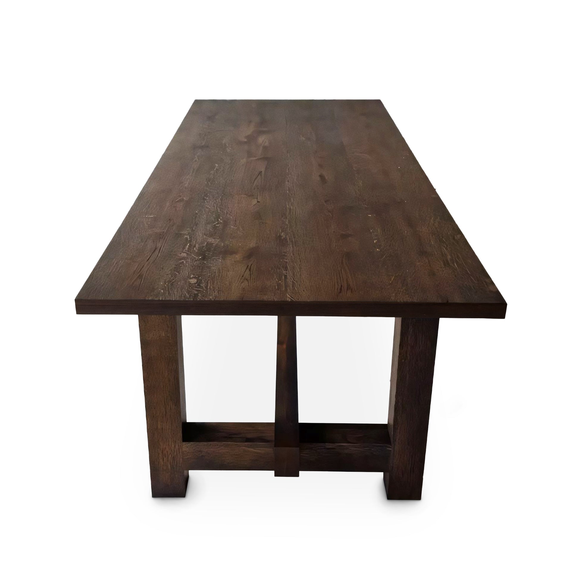 Detailed view of the Elsa rustic farmer-style dining table in rich chocolate oak, showcasing bespoke craftsmanship and FSC certified solid wood planks. This rectangular, extendable table by Talia Haus is a luxurious and sustainable piece, available in custom sizes and finishes including oak and walnut. A premium, handcrafted design perfect for elegant and timeless interiors.