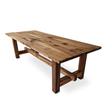 ELSA rustic farmer-style dining table made of solid walnut wood, rectangular and extendable, with open leg design, shown from a long corner view.
