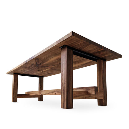 ELSA rustic farmer-style dining table made of solid walnut wood, rectangular and extendable, with open leg design, shown from a long undertable view.
