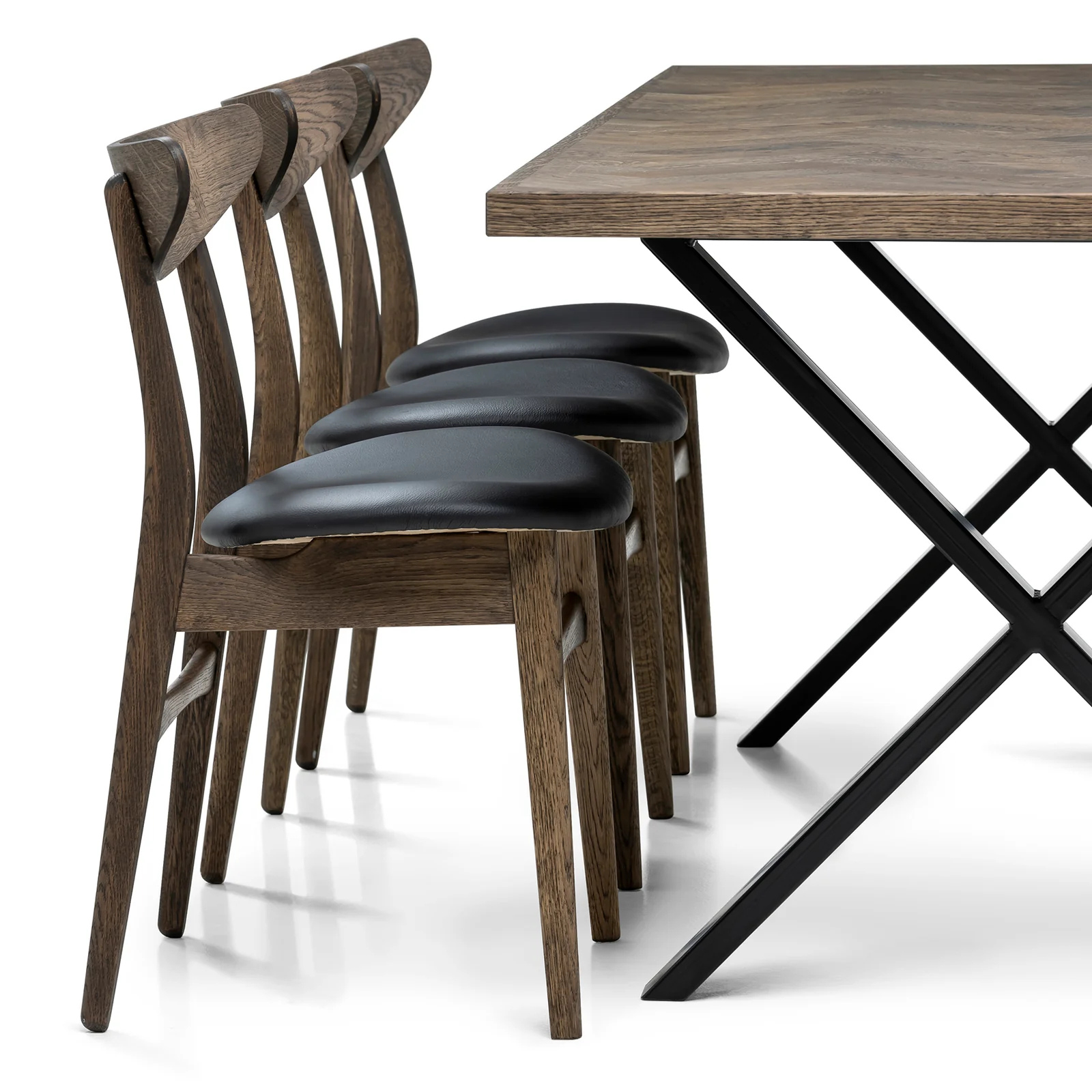 Gaia herringbone solid wood extendable dining table in charcoal oak with cross metal legs – luxury solid wood furniture piece.