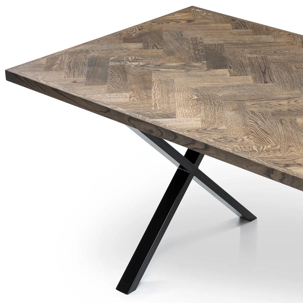 Gaia herringbone solid wood extendable dining table in charcoal oak with cross metal legs – luxury solid wood furniture piece.