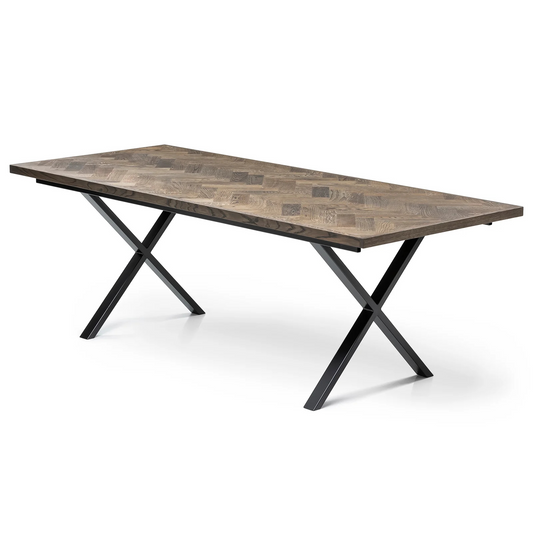 Gaia herringbone solid wood extendable dining table in charcoal oak with cross metal legs – luxury solid wood furniture piece.