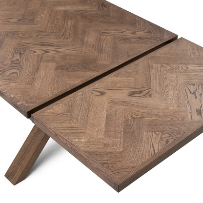 Gaia herringbone solid wood extendable dining table in chocolate oak with cross wood legs – luxury solid wood furniture piece.