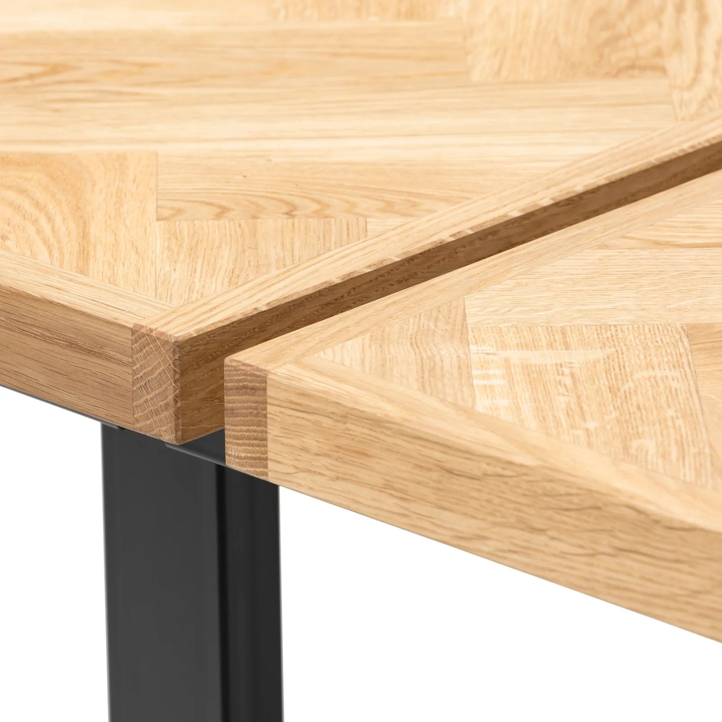 Gaia herringbone solid wood extendable dining table in clear oak with square metal legs – luxury solid wood furniture, custom made.