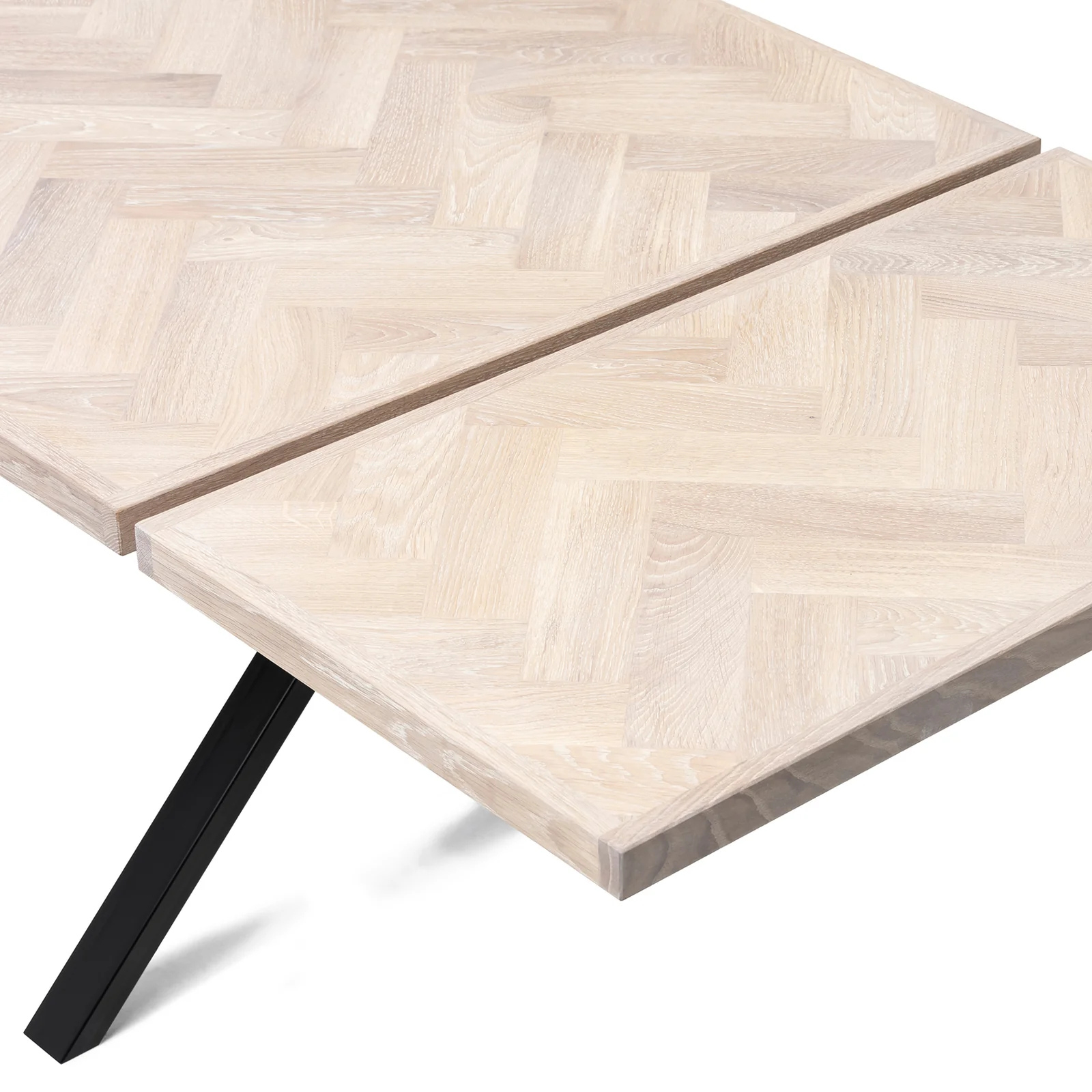 Gaia herringbone solid wood extendable dining table in white oak with cross metal legs – luxury solid wood furniture piece.