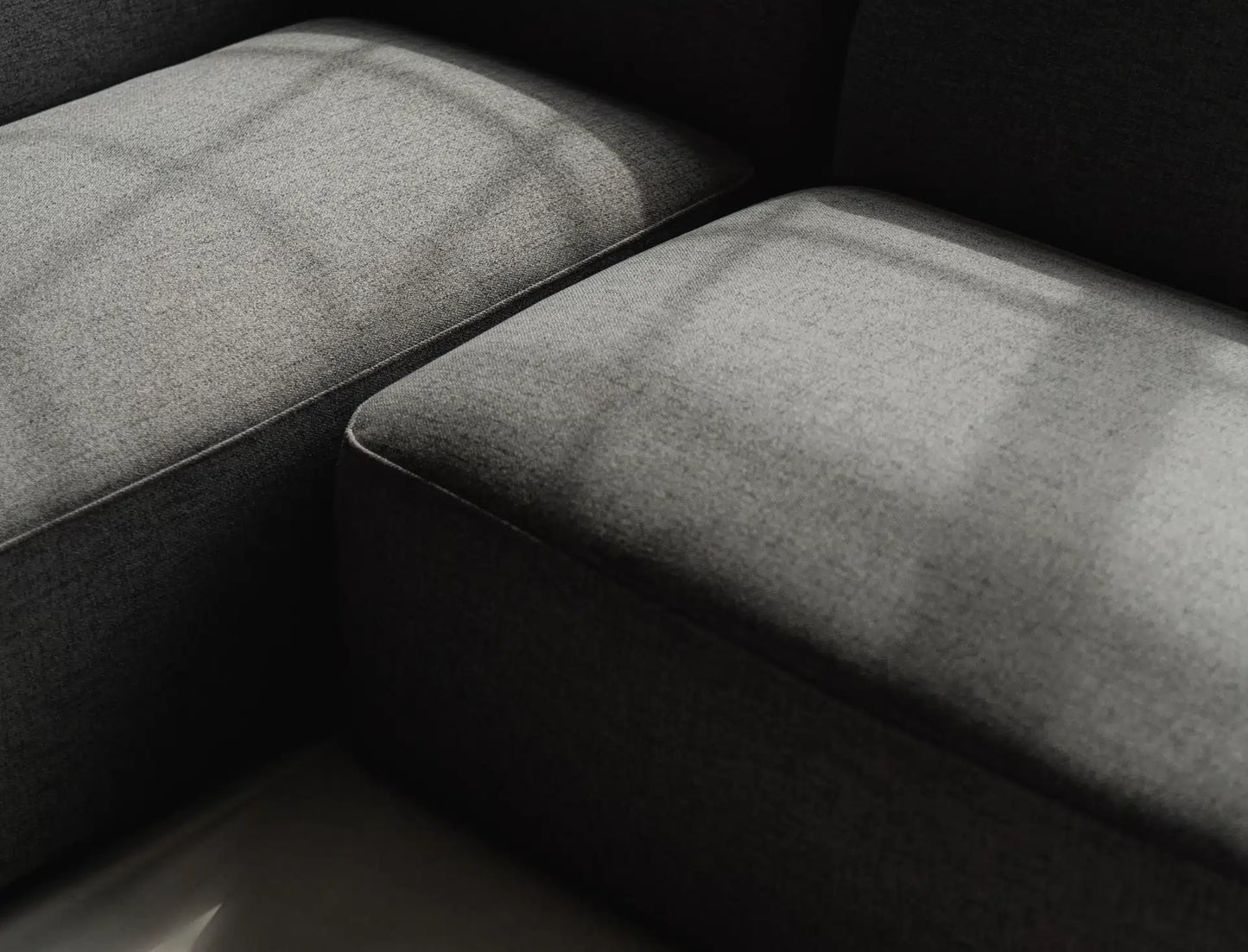 Close-up of a textured gray surface with a dark background