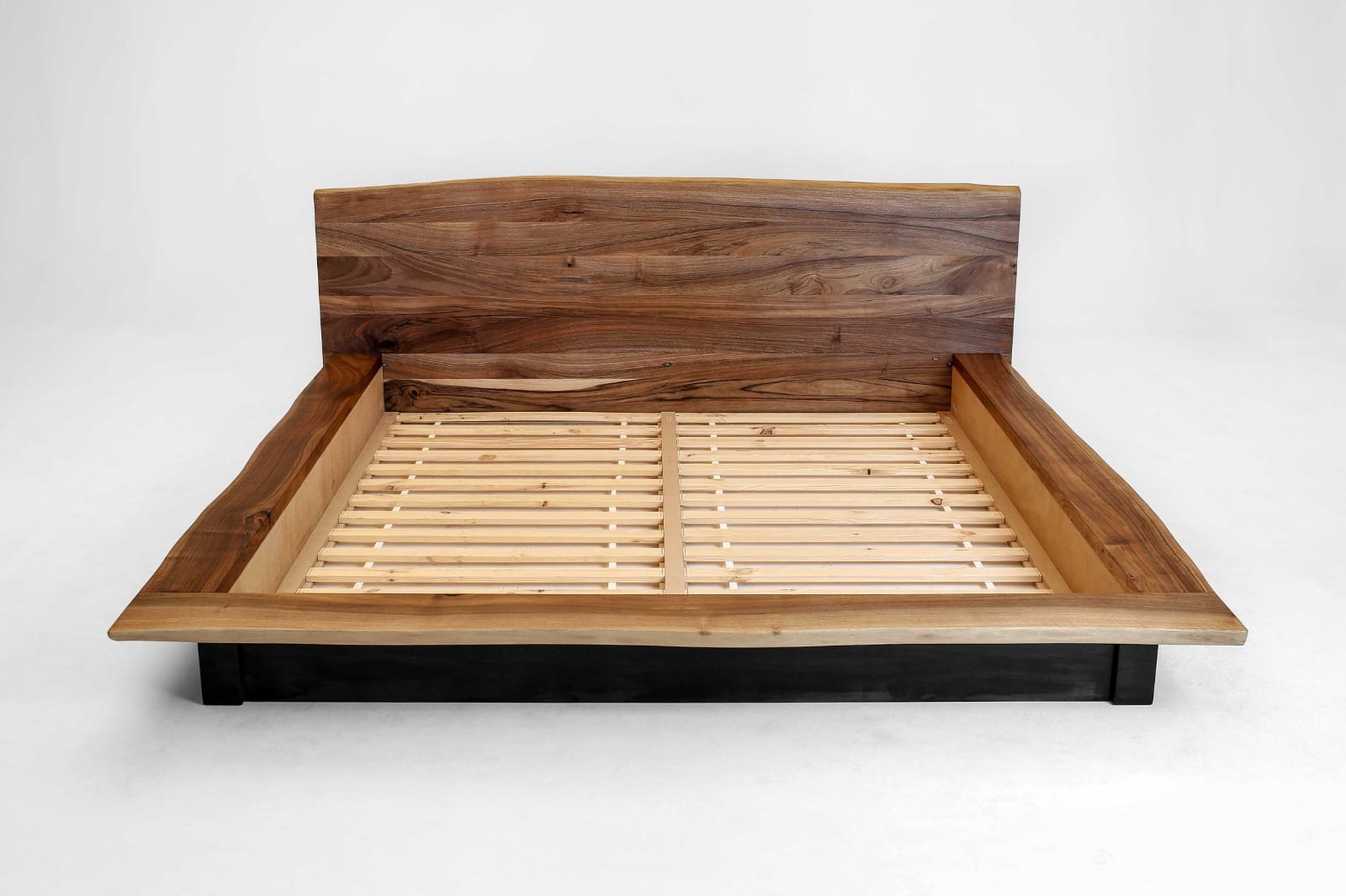 Kyma handcrafted solid wood bed in clear walnut featuring a live edge made by artisans. Handmade in Europe. 