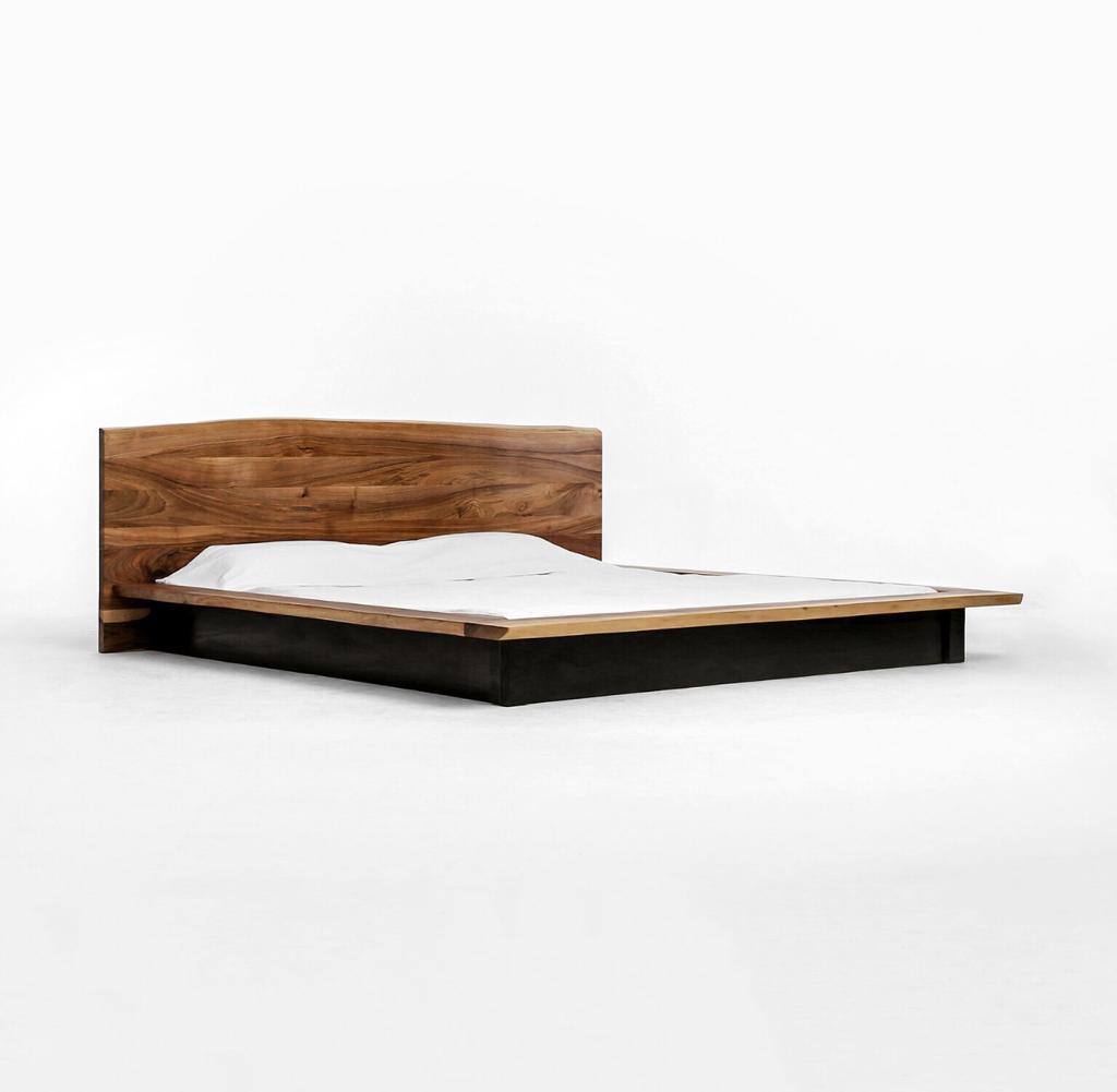 Kyma handcrafted solid wood bed in clear walnut featuring a live edge made by artisans. Handmade in Europe. 