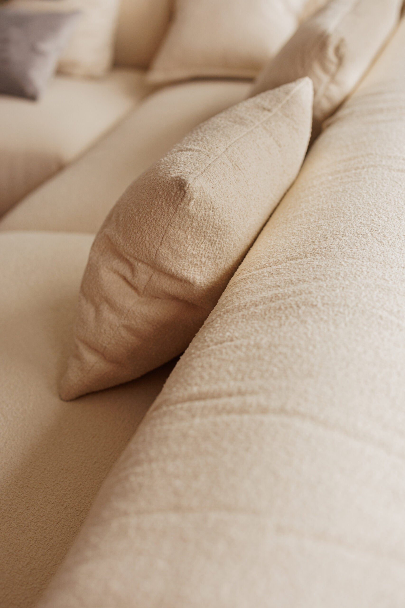 Close-up of beige pillows on a textured surface