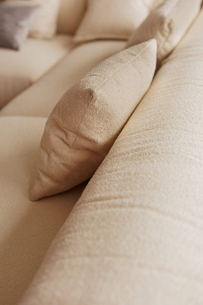 Close-up of beige pillows on a textured surface