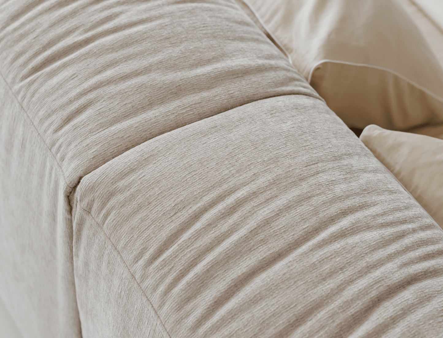 Close-up of beige textured fabric with a soft, smooth finish.