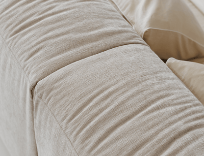 Close-up of beige textured fabric with a soft, smooth finish.