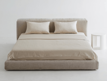 Premium quality bed with matching headboard and pillows against a white wall.