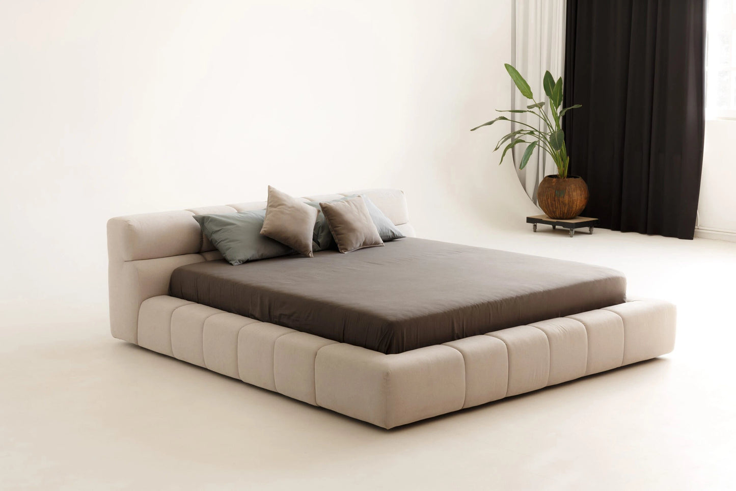Modern platform bed with beige frame and brown mattress in a minimalistic room.