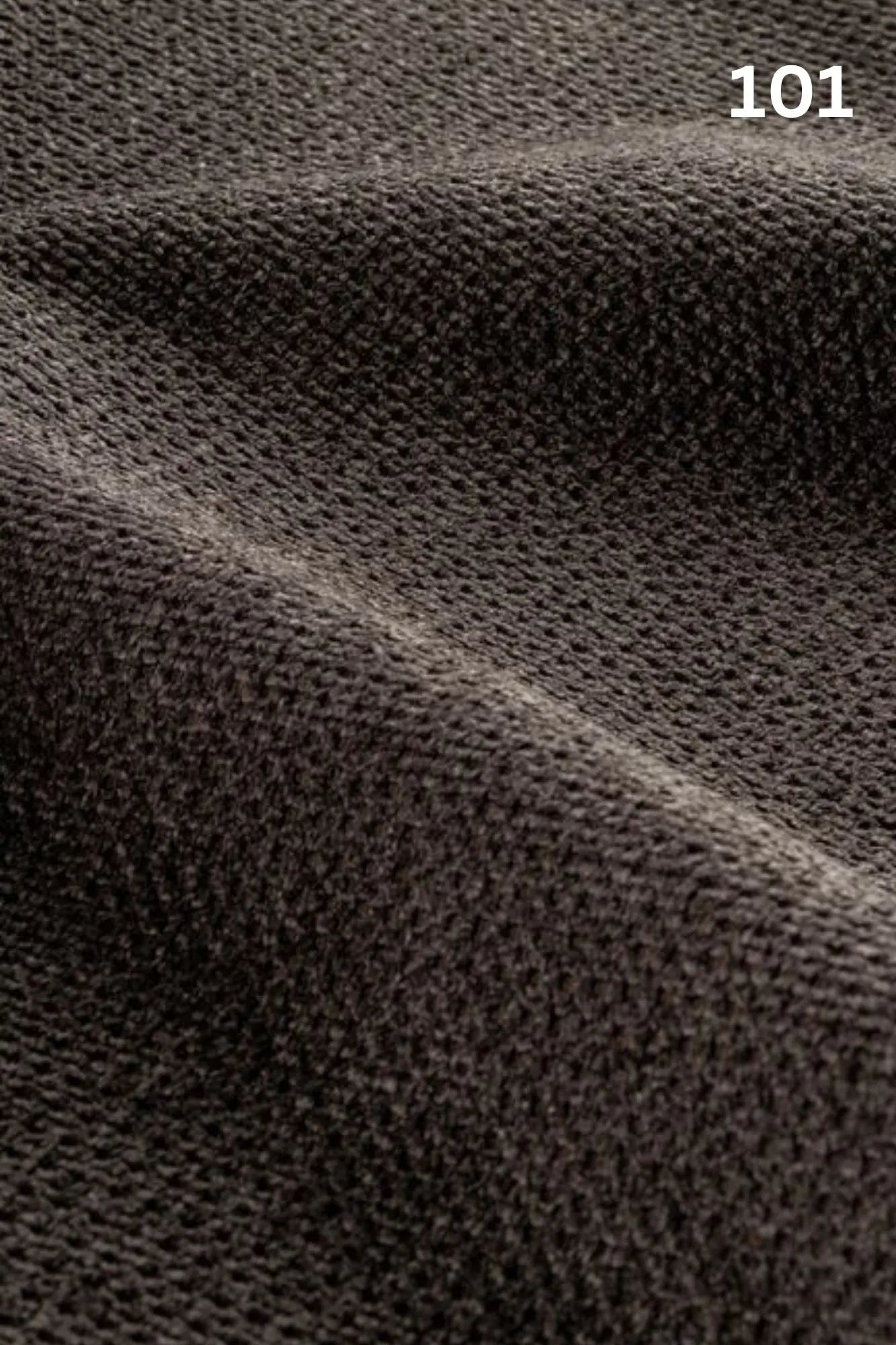 Close-up of black fabric texture with a slight wave pattern and number '101' in the corner. 