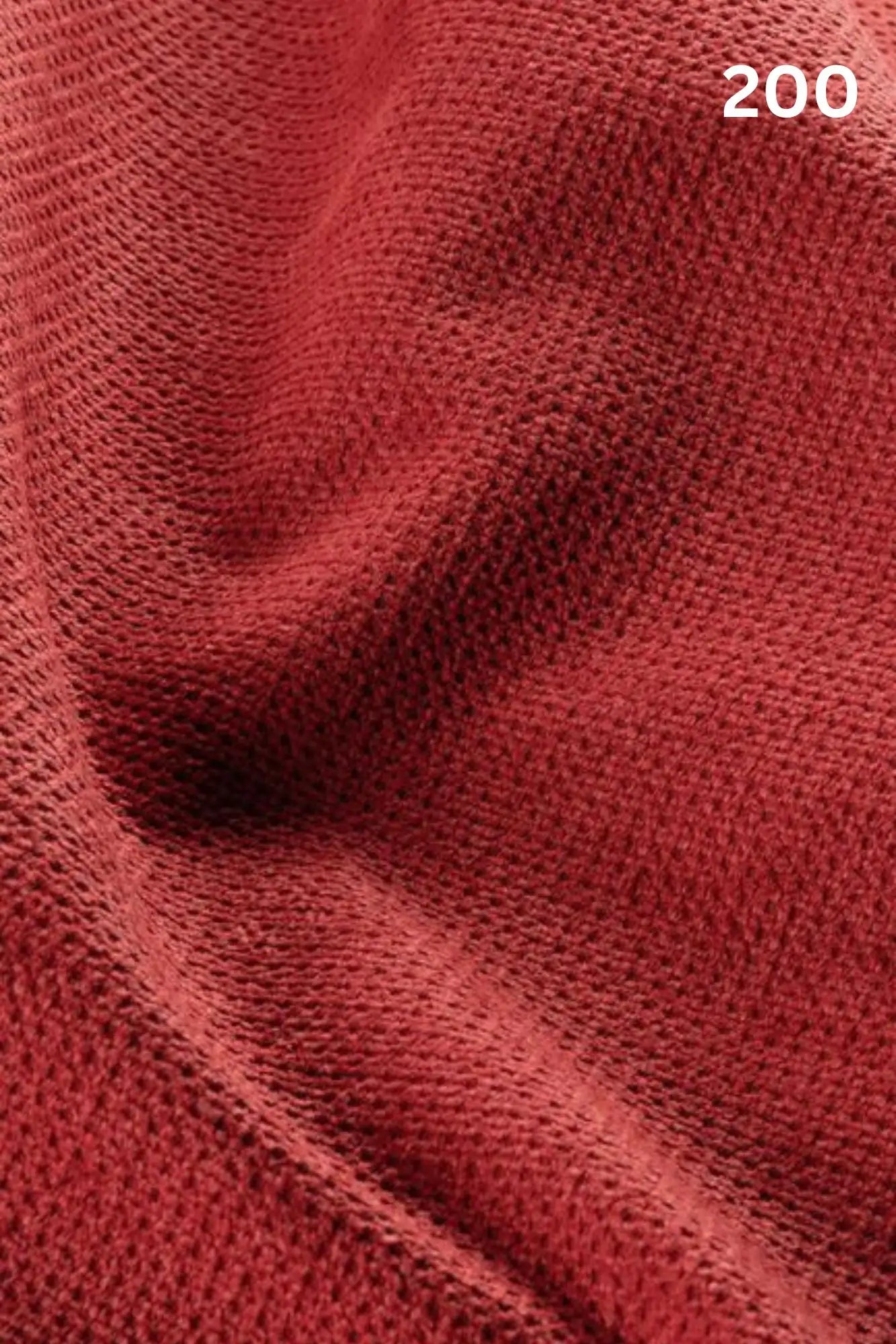Close-up of red fabric texture with a slight wave pattern and number '200' in the corner. 