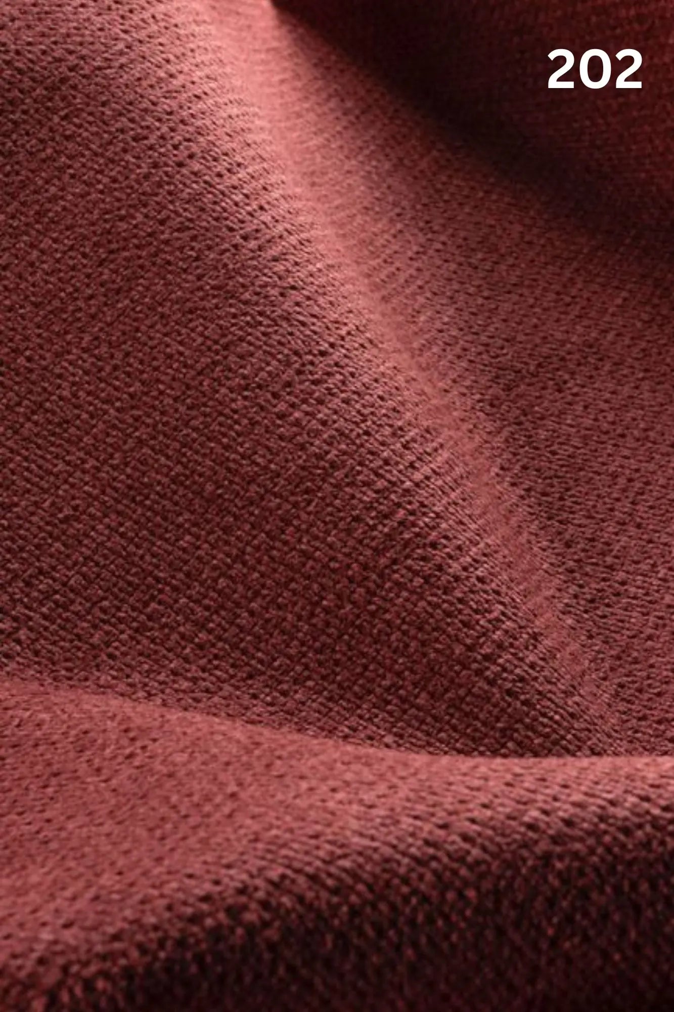 Close-up of red fabric texture with a slight wave pattern and number '202' in the corner. 