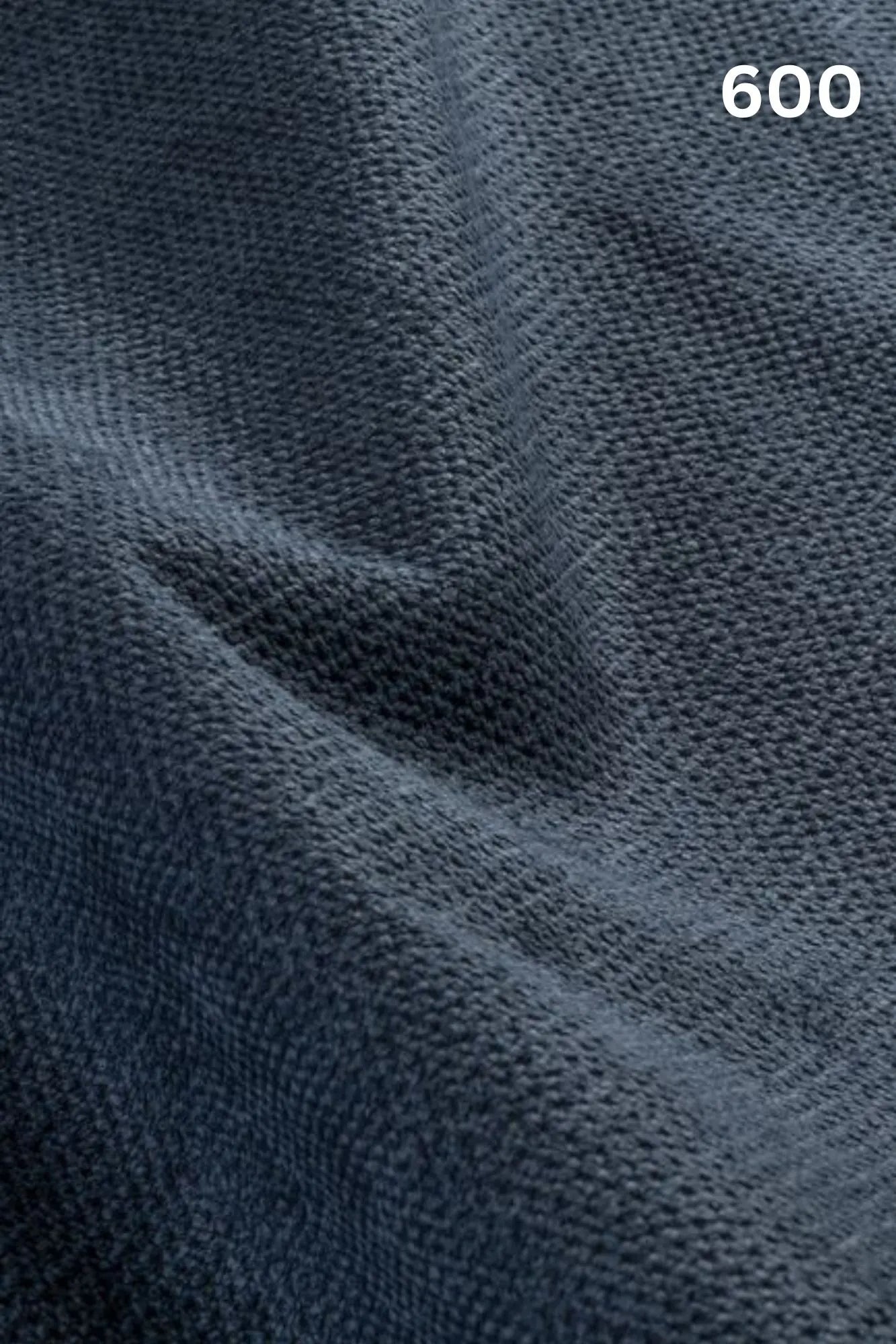 Close-up of blue fabric texture with a slight wave pattern and number '600' in the corner. 
