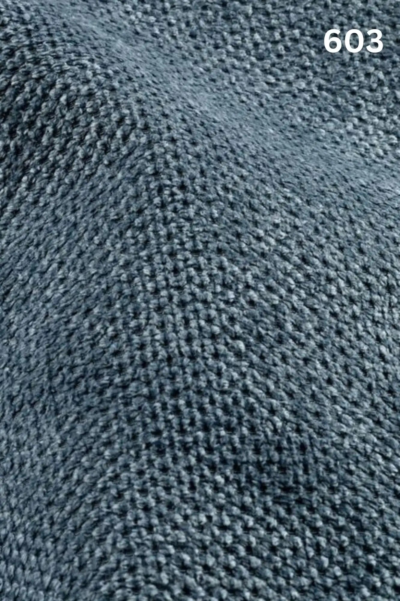 Close-up of blue fabric texture with a slight wave pattern and number '603' in the corner. 