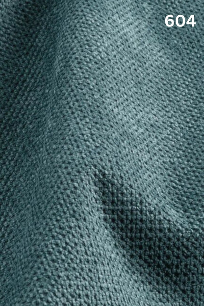 Close-up of blue fabric texture with a slight wave pattern and number '604' in the corner. 