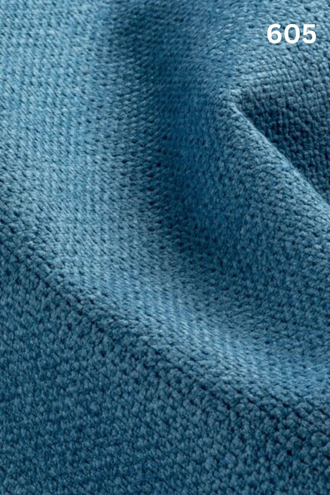 Close-up of blue fabric texture with a slight wave pattern and number '605' in the corner. 