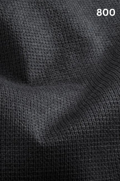 Close-up of black fabric texture with a slight wave pattern and number '800' in the corner. 