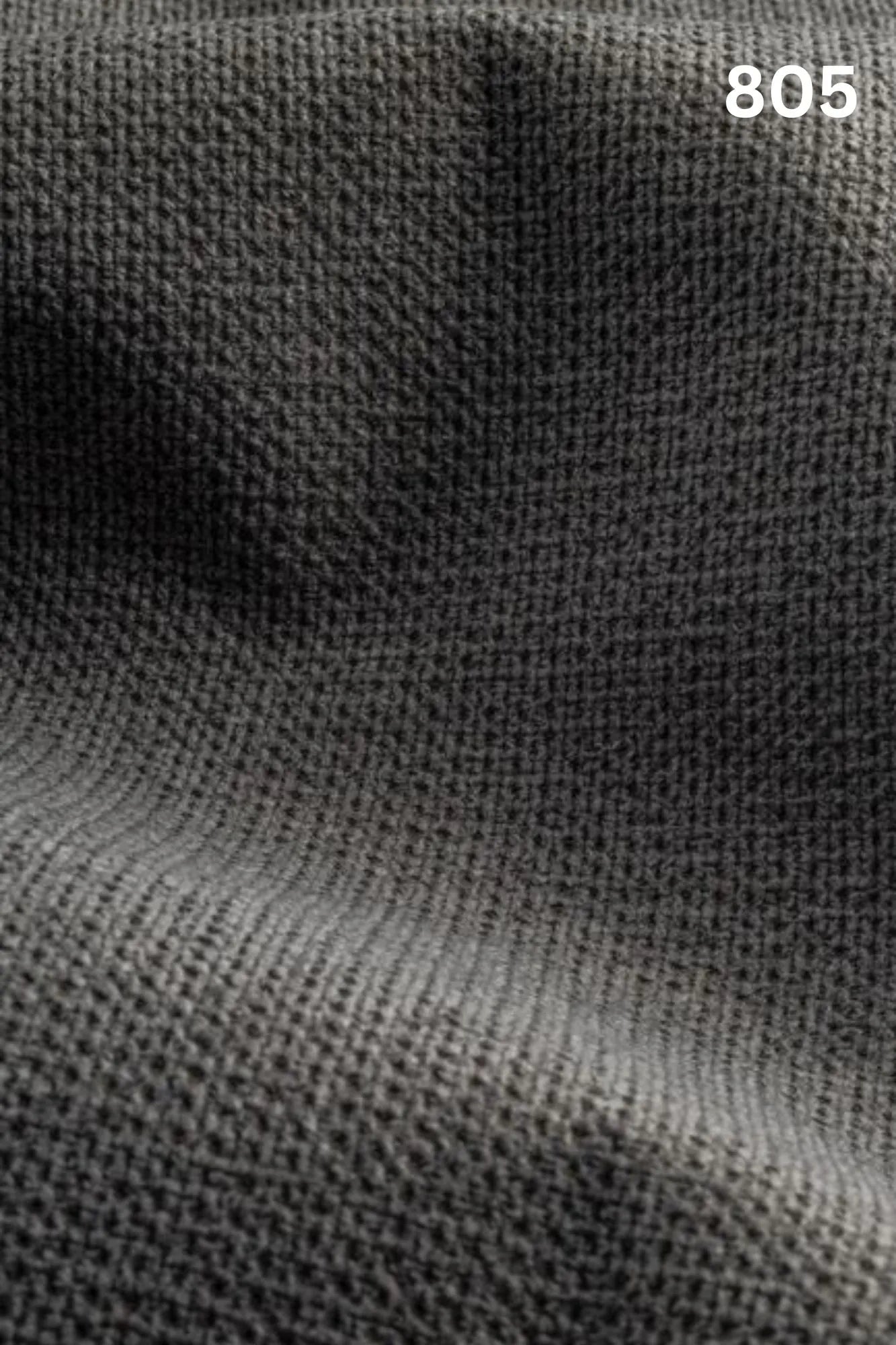Close-up of black fabric texture with a slight wave pattern and number '805' in the corner. 