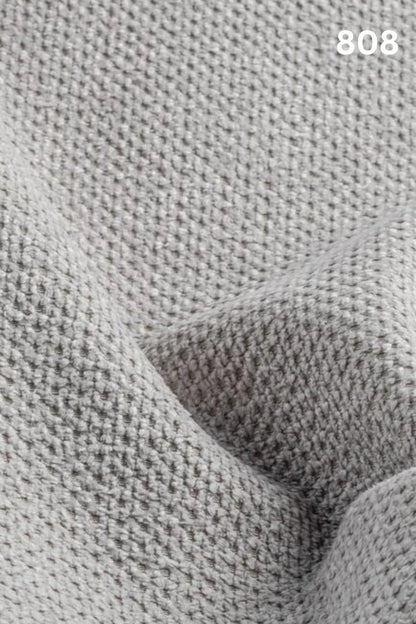 Close-up of white fabric texture with a slight wave pattern and number '808' in the corner. 