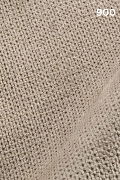 Close-up of beige fabric texture with a slight wave pattern and number '900' in the corner. 