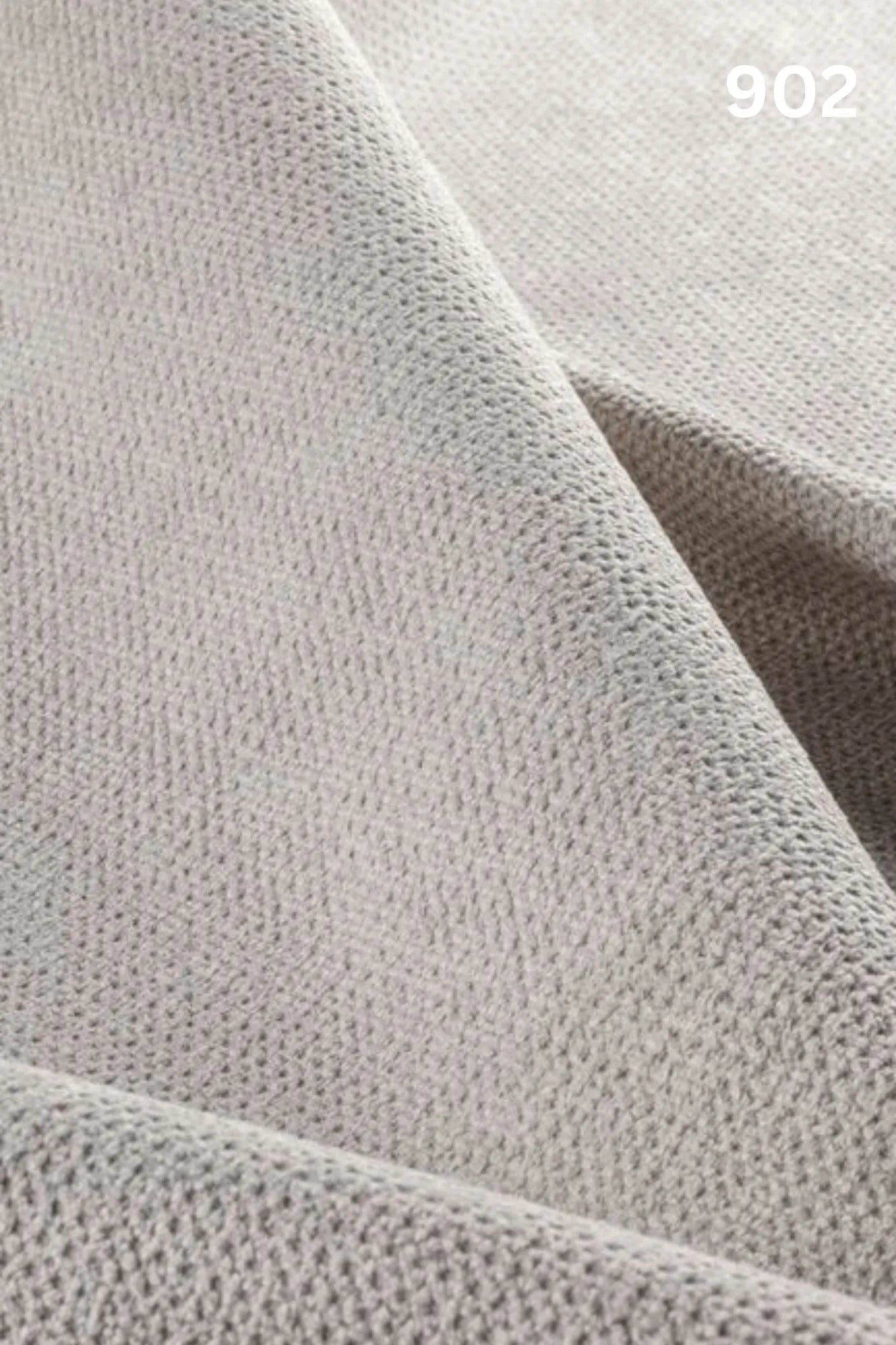Close-up of white fabric texture with a slight wave pattern and number '902' in the corner. 