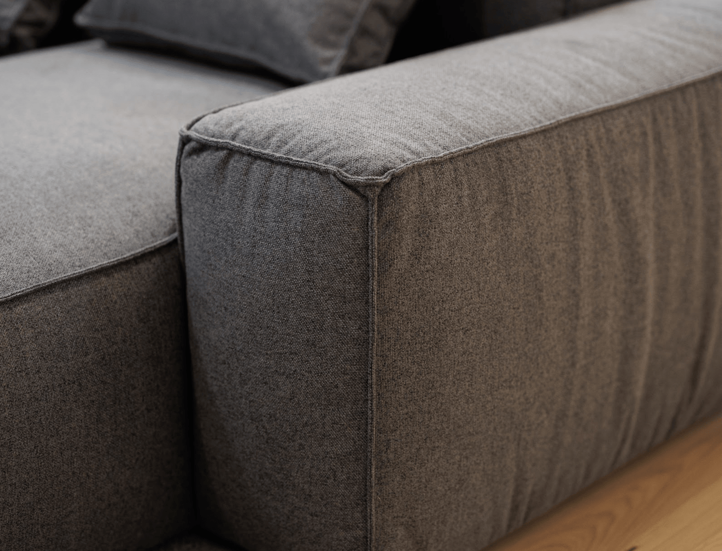 Premium black fabric sofa corner on a wooden floor