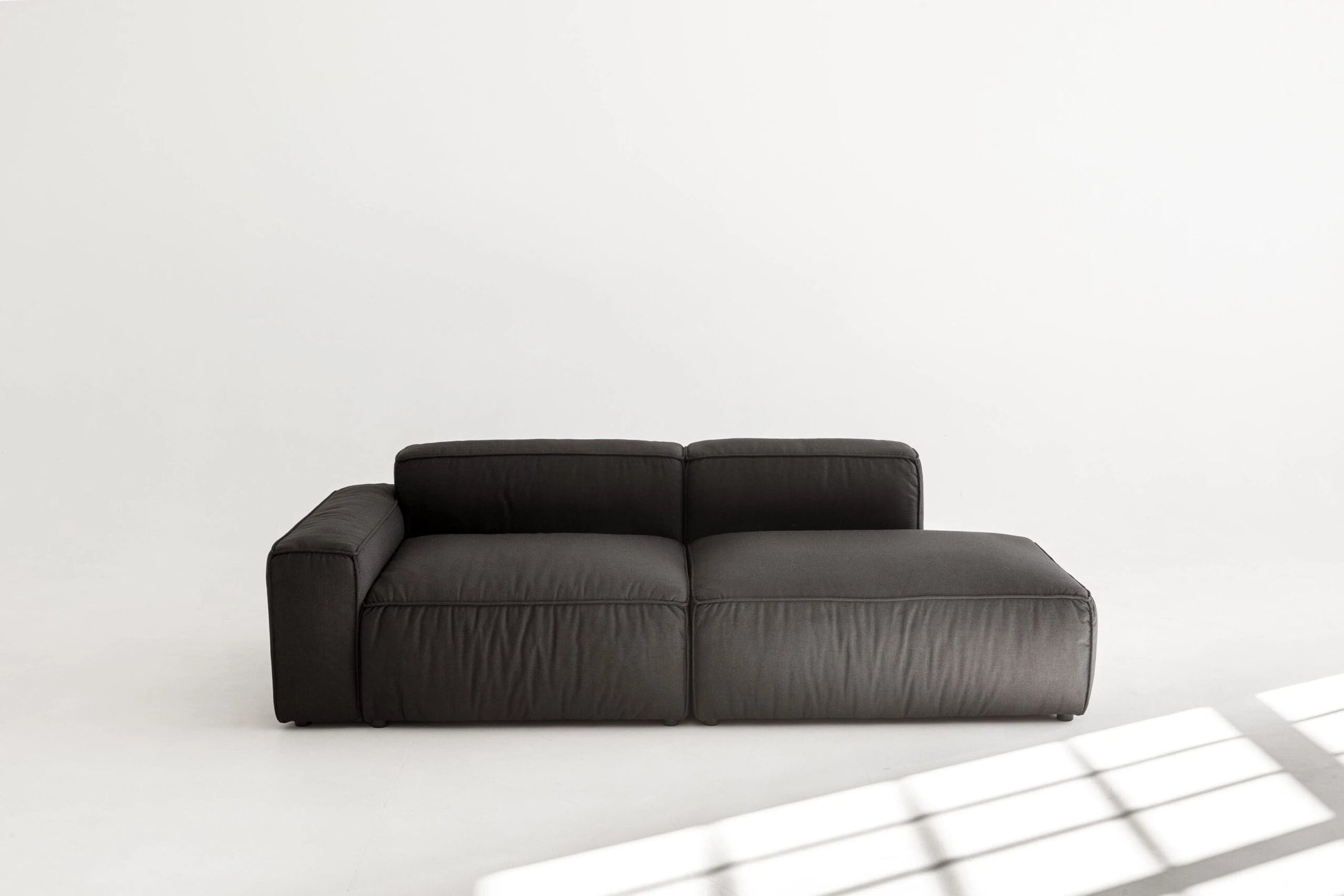 Black modular sofa on a white background