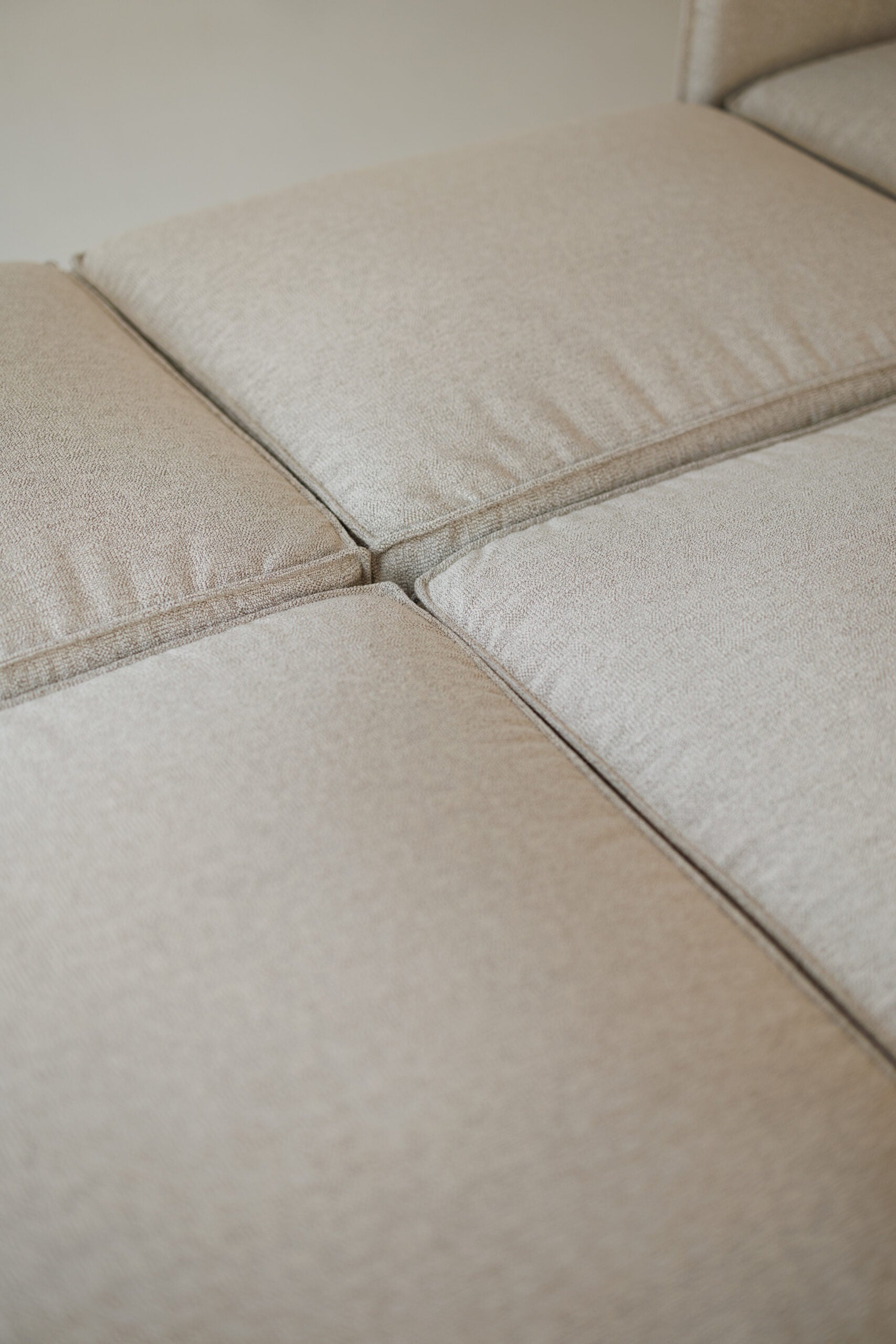 Milano modular sofa in premium Belgian fabric, corner view – extendable bespoke sofa with built-in storage, low-profile modern design, upholstered in premium durable fabric, featuring polyurethane and memory foam seat cushions with plywood frame. Stylish and functional seating and sleeping solution for contemporary interiors.