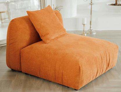 Orange modular armchair chair with cushions on a wooden floor.