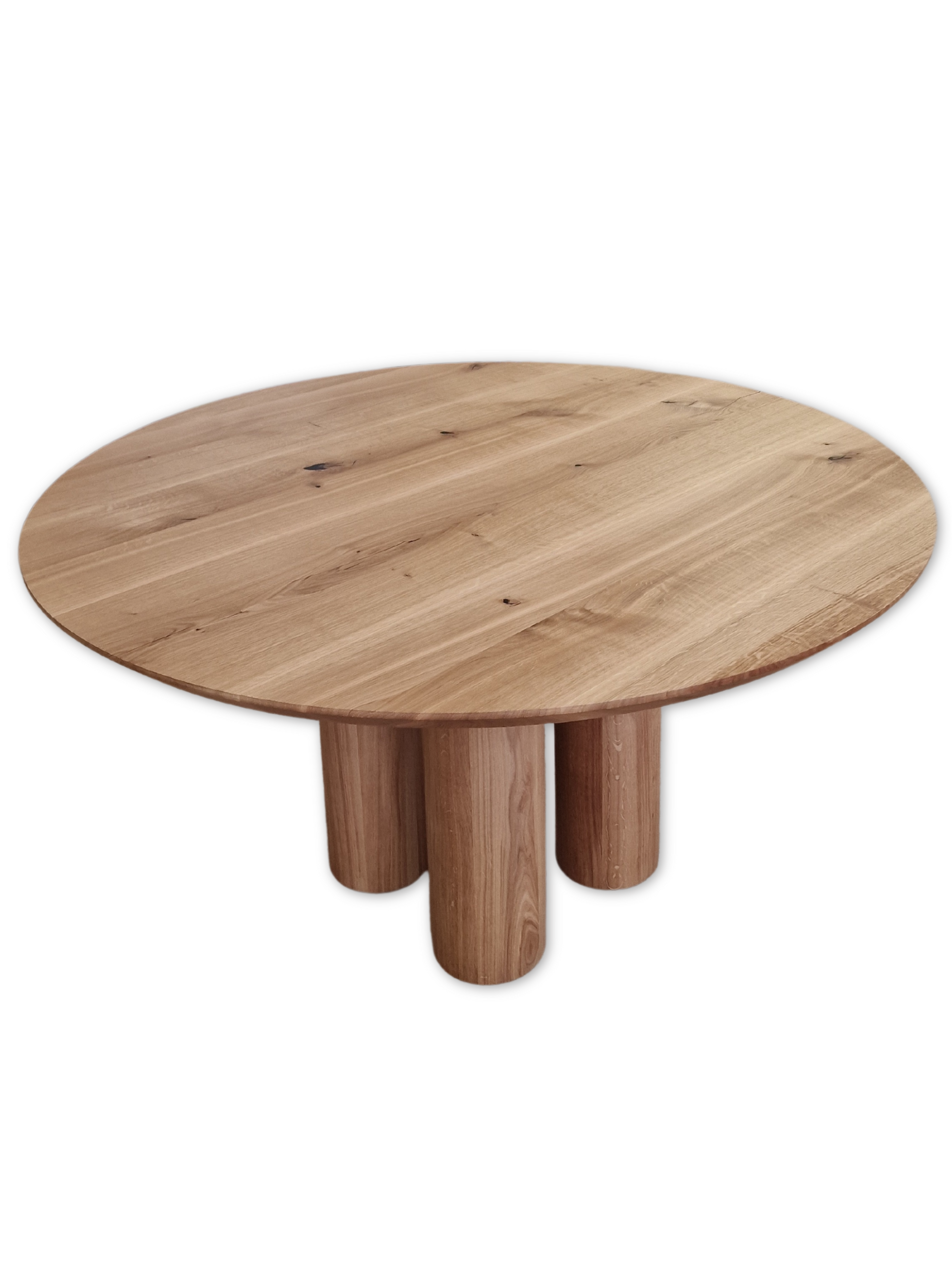 Handcrafted solid wood dining table with four round legs in natural oak. 