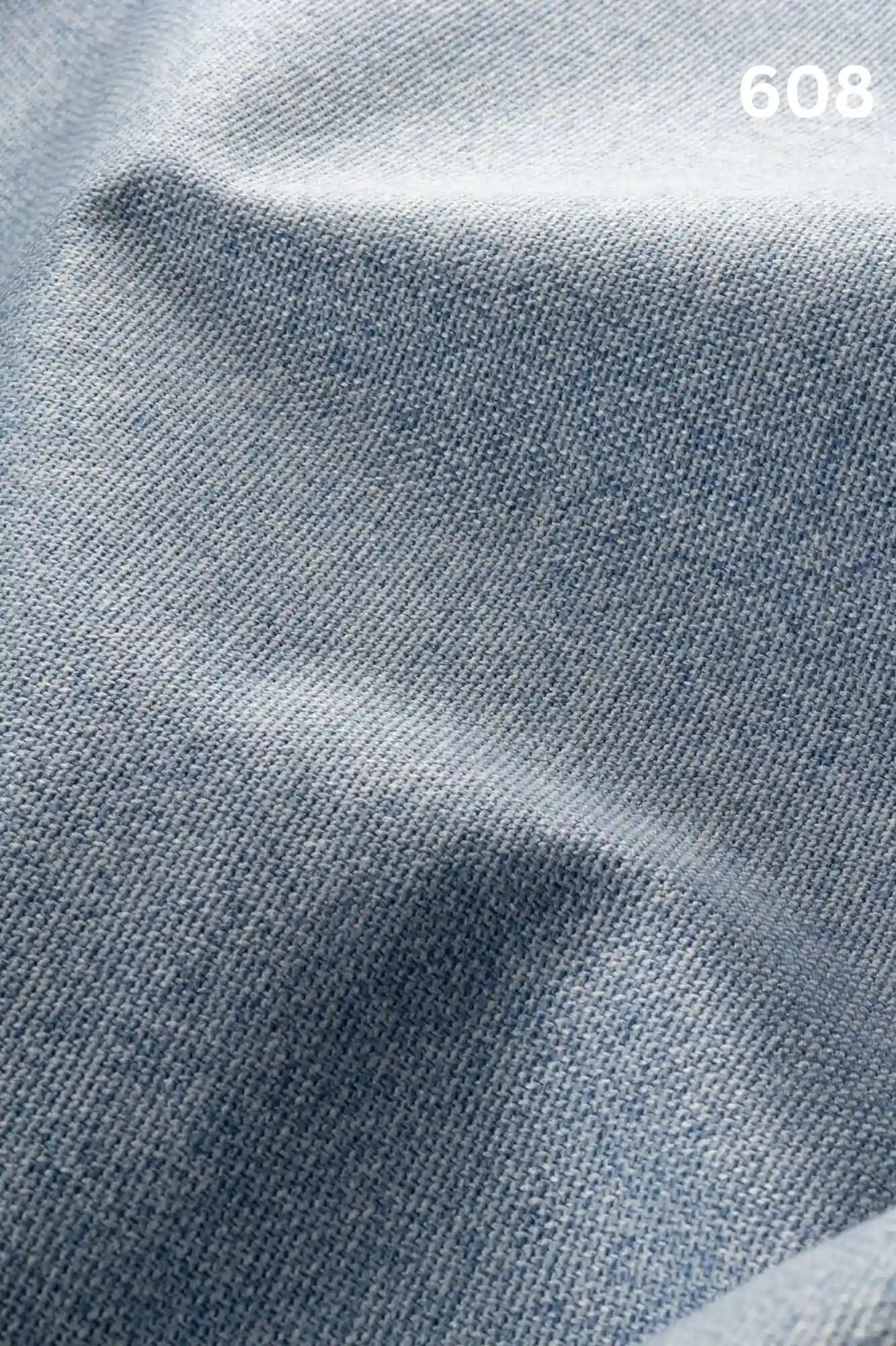 Close-up of light blue woven textured fabric for sofas with number '608' in the corner. 