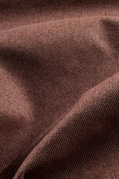 Close-up of orange colored woven textured fabric for sofas. 