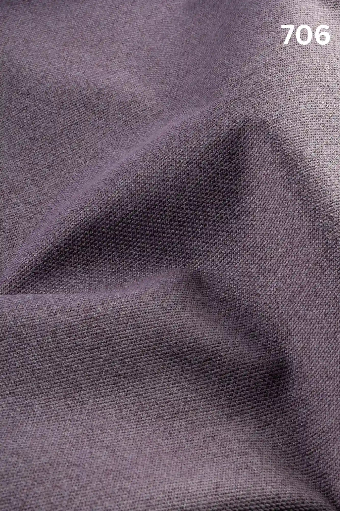 Close-up of violet colored woven textured fabric for sofas with number '706' in the corner. 