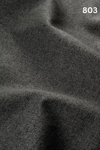 Close-up of black colored woven textured fabric for sofas with number '803' in the corner. 