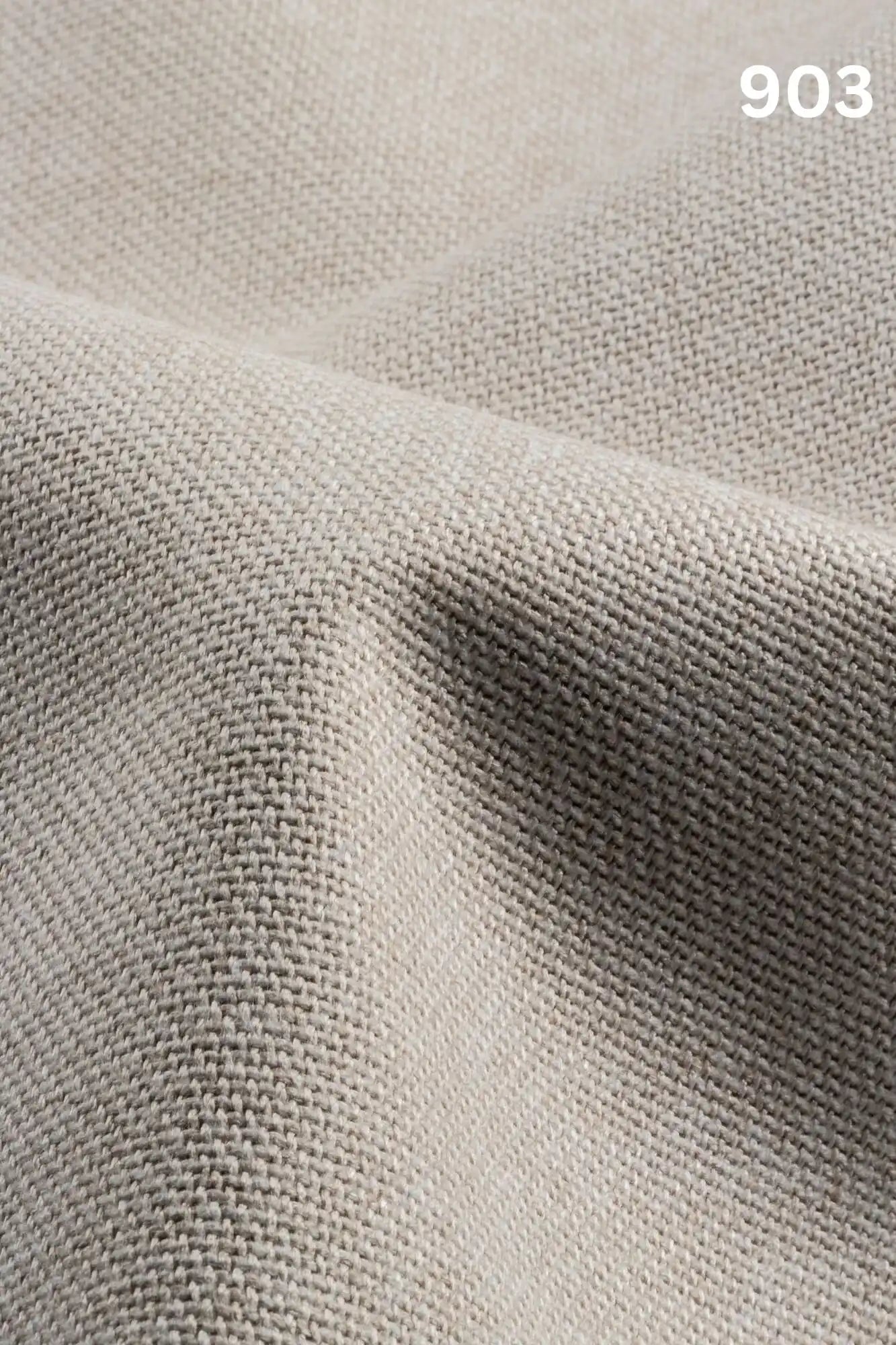 Close-up of white colored woven textured fabric for sofas with number '903' in the corner. 