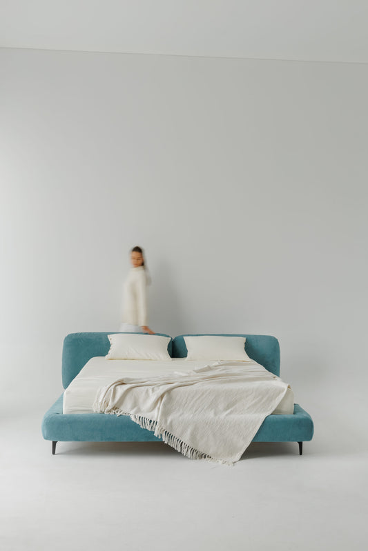 TESA bed upholstered in premium blue fabric, custom bespoke designer luxury, showcased in a photoshoot by Talia Haus.
