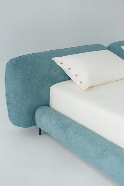 TESA bed upholstered in premium blue fabric, custom bespoke designer luxury, showcased in a photoshoot by Talia Haus.
