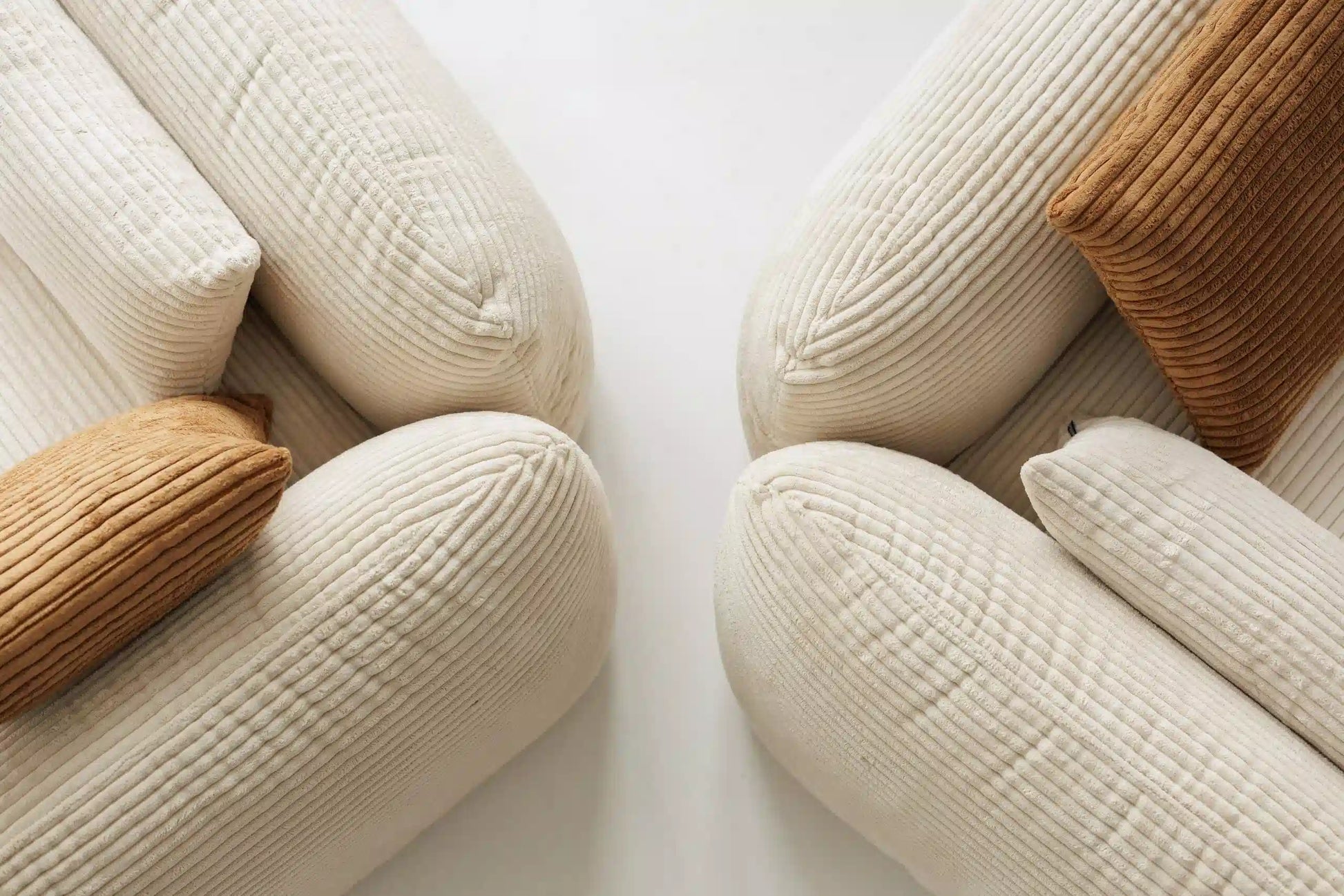 Textured pillows in beige and brown on a white background