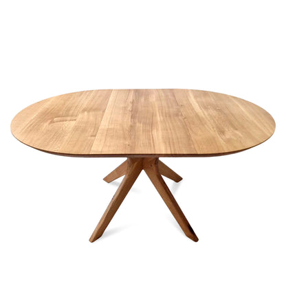 Vera extendable round dining table in clear oak with solid wood spider legs, natural finish, middle extension, 3cm thick top, handcrafted from FSC-certified solid oak, customizable size, color, and edge.
